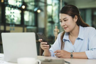 Businesswoman Engaging with Mobile Phone Technology. Digital Entrepreneurship.