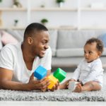 Development Games For Babies. Black Father Playing Stacking Blocks With Infant Child